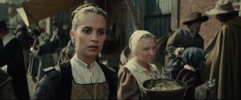 Movie still from “Tulip Fever” (2017), directed by Justin Chadwick – Two women dressed in period clothing in an old - fashioned kitchen; Close Up shot, Over the shoulder angle