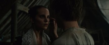 Movie still from “Tulip Fever” (2017), directed by Justin Chadwick – A woman looking into a mirror while another woman holds her hand up to her ear; Close Up shot, Over the shoulder angle