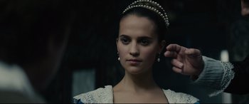 Movie still from “Tulip Fever” (2017), directed by Justin Chadwick – A young woman wearing a tiara and a white dress; Close Up shot, Over the shoulder angle