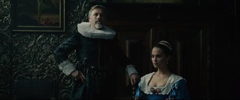 Movie still from “Tulip Fever” (2017), directed by Justin Chadwick – A man and a woman dressed in renaissance clothing; Medium shot, Low angle