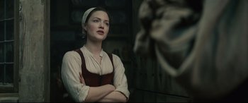 Movie still from “Tulip Fever” (2017), directed by Justin Chadwick – A woman in a medieval dress looking at a statue; Medium shot, Over the shoulder angle