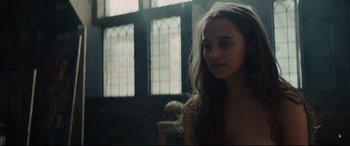 Movie still from “Tulip Fever” (2017), directed by Justin Chadwick – A young woman with long hair is standing in front of a window; Close Up shot, Over the shoulder angle