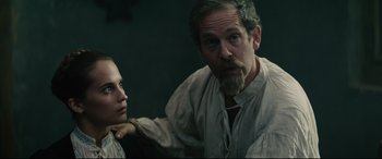 Movie still from “Tulip Fever” (2017), directed by Justin Chadwick – A man and a woman standing next to each other; Medium shot, Over the shoulder angle