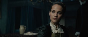 Movie still from “Tulip Fever” (2017), directed by Justin Chadwick – A woman in a black and white outfit looking at the camera; Close Up shot, Over the shoulder angle