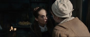 Movie still from “Tulip Fever” (2017), directed by Justin Chadwick – A woman looking into a mirror while wearing a hat; Close Up shot, Over the shoulder angle