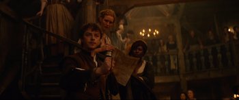 Movie still from “Tulip Fever” (2017), directed by Justin Chadwick – A group of people standing around in a room; Medium shot, High angle