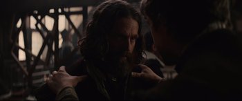 Movie still from “Tulip Fever” (2017), directed by Justin Chadwick – A man with long hair and a long beard; Close Up shot, Over the shoulder angle