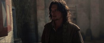 Movie still from “Tulip Fever” (2017), directed by Justin Chadwick – A person with long curly hair; Medium shot, Over the shoulder angle