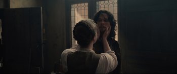 Movie still from “Tulip Fever” (2017), directed by Justin Chadwick – A woman standing in front of a mirror with a man; Medium shot, Over the shoulder angle