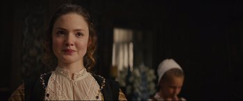 Movie still from “Tulip Fever” (2017), directed by Justin Chadwick – A young woman wearing a dress and a head scarf; Close Up shot, Over the shoulder angle