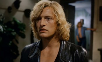 Movie still from “Turkish Delight” (1973), directed by Paul Verhoeven – A person wearing a leather jacket; Close Up shot, Low angle