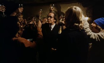 Movie still from “Turkish Delight” (1973), directed by Paul Verhoeven – A group of people holding wine glasses in their hands; Medium shot, Low angle