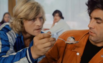 Movie still from “Turkish Delight” (1973), directed by Paul Verhoeven – A man holding a fork with a piece of cake on top of it; Close Up shot, Low angle