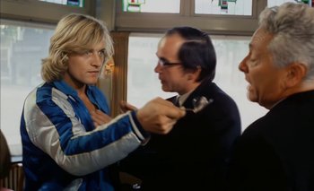 Movie still from “Turkish Delight” (1973), directed by Paul Verhoeven – Two men and a woman fighting in front of a window; Medium shot, Over the shoulder angle