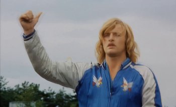 Movie still from “Turkish Delight” (1973), directed by Paul Verhoeven – A man with long blonde hair and a blue jacket; Medium shot, Low angle