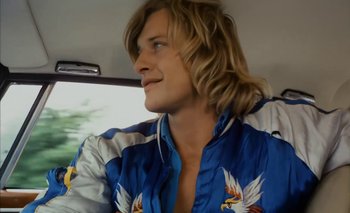 Movie still from “Turkish Delight” (1973), directed by Paul Verhoeven – A man with long blonde hair sitting in a car; Close Up shot, Low angle