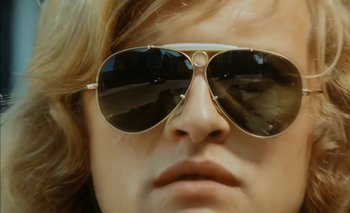 Movie still from “Turkish Delight” (1973), directed by Paul Verhoeven – A person wearing sunglasses; Close Up shot, Low angle