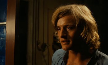 Movie still from “Turkish Delight” (1973), directed by Paul Verhoeven – A man with blonde hair is looking at the camera; Close Up shot, Over the shoulder angle