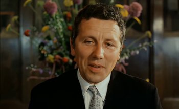 Movie still from “Turkish Delight” (1973), directed by Paul Verhoeven – A person wearing a suit and tie; Close Up shot, Low angle