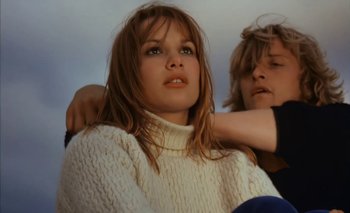 Movie still from “Turkish Delight” (1973), directed by Paul Verhoeven – A woman in a white sweater and a man in a blue shirt; Medium shot, Low angle
