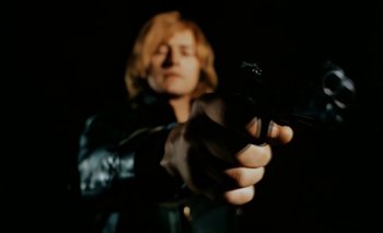 Movie still from “Turkish Delight” (1973), directed by Paul Verhoeven – A woman is holding a gun in her hand; Close Up shot, Low angle