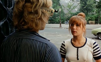 Movie still from “Turkish Delight” (1973), directed by Paul Verhoeven – A woman talking to a man in a striped shirt; Medium shot, Over the shoulder angle