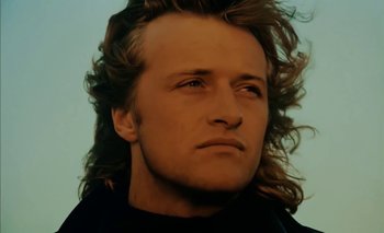 Movie still from “Turkish Delight” (1973), directed by Paul Verhoeven – A person with long curly hair; Close Up shot, Low angle