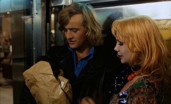 Movie still from “Turkish Delight” (1973), directed by Paul Verhoeven – A man and a woman are looking at a bag; Medium shot, Over the shoulder angle