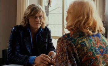 Movie still from “Turkish Delight” (1973), directed by Paul Verhoeven – Two people sitting at a table talking to each other; Medium shot, Over the shoulder angle