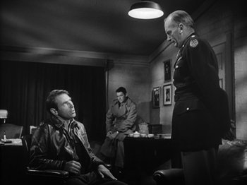 Movie still from “Twelve O'Clock High” (1949), directed by Henry King – Two men and a woman in a room; Medium shot, Over the shoulder angle