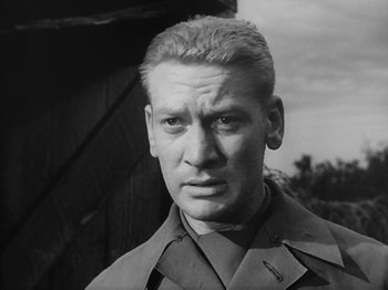 Movie still from “Twelve O'Clock High” (1949), directed by Henry King – An old black and white photo of a man in uniform; Close Up shot, Low angle