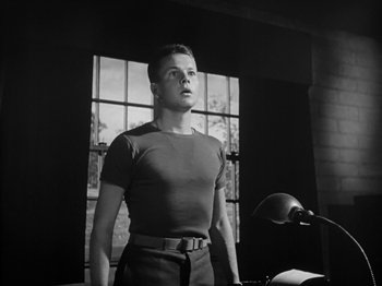Movie still from “Twelve O'Clock High” (1949), directed by Henry King – A man standing in front of a window in a room; Medium shot, Low angle