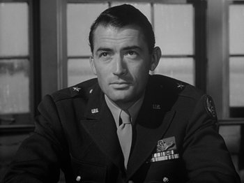 Movie still from “Twelve O'Clock High” (1949), directed by Henry King – A man in a military uniform sitting in front of a window; Close Up shot, Low angle