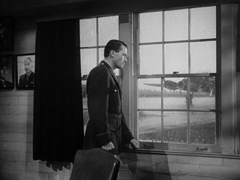 Movie still from “Twelve O'Clock High” (1949), directed by Henry King – A black and white photo of a man standing in front of a window; Medium shot, Low angle