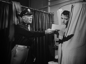 Movie still from “Twelve O'Clock High” (1949), directed by Henry King – An old photo of a man handing a letter to another man; Medium shot, Low angle