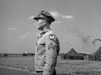 Movie still from “Twelve O'Clock High” (1949), directed by Henry King – An old photo of a man in a military uniform; Medium shot, Low angle