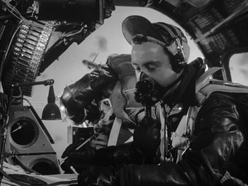 Movie still from “Twelve O'Clock High” (1949), directed by Henry King – A black and white photo of a man in a helicopter; Medium shot, Low angle