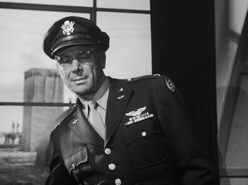 Movie still from “Twelve O'Clock High” (1949), directed by Henry King – An old photo of a man in a military uniform; Medium shot, Low angle
