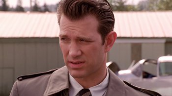 Movie still from “Twin Peaks: Fire Walk with Me” (1992), directed by David Lynch – A person wearing a suit and tie; Close Up shot, Over the shoulder angle