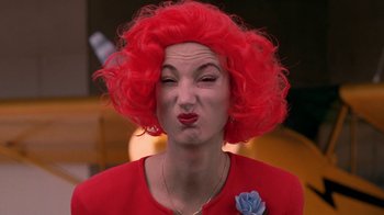 Movie still from “Twin Peaks: Fire Walk with Me” (1992), directed by David Lynch – A woman with red hair and a blue flower in her hair; Close Up shot, Over the shoulder angle