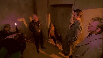 Movie still from “Twin Peaks: Fire Walk with Me” (1992), directed by David Lynch – A group of people standing around in a room; Wide shot, High angle