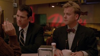 Movie still from “Twin Peaks: Fire Walk with Me” (1992), directed by David Lynch – Two men in suits sitting at a dinner table; Close Up shot, Low angle