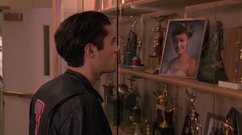 Movie still from “Twin Peaks: Fire Walk with Me” (1992), directed by David Lynch – A man looking at a mirror with a picture of a young boy in it; Close Up shot, Over the shoulder angle