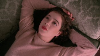 Movie still from “Twin Peaks: Fire Walk with Me” (1992), directed by David Lynch – A woman laying on the ground with her eyes closed; Close Up shot, Overhead angle