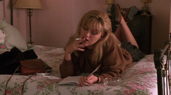 Movie still from “Twin Peaks: Fire Walk with Me” (1992), directed by David Lynch – A woman smoking a cigarette while lying on a bed; Medium shot, Overhead angle