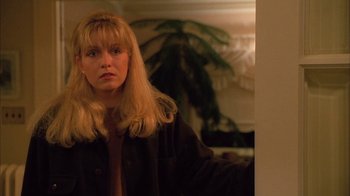 Movie still from “Twin Peaks: Fire Walk with Me” (1992), directed by David Lynch – A woman with long blonde hair standing next to a tree; Close Up shot, Over the shoulder angle