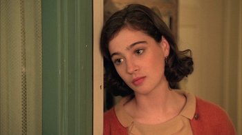 Movie still from “Twin Peaks: Fire Walk with Me” (1992), directed by David Lynch – A young woman standing in front of a green door; Close Up shot, Over the shoulder angle