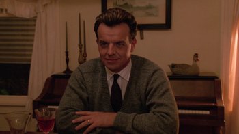 Movie still from “Twin Peaks: Fire Walk with Me” (1992), directed by David Lynch – A man sitting in front of a piano in a room; Close Up shot, Low angle