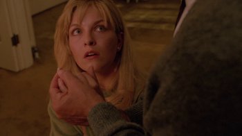 Movie still from “Twin Peaks: Fire Walk with Me” (1992), directed by David Lynch – A woman looking up at a man with his hand on her shoulder; Close Up shot, High angle