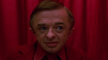 Movie still from “Twin Peaks: Fire Walk with Me” (1992), directed by David Lynch – A person wearing a suit and tie; Close Up shot, Low angle
